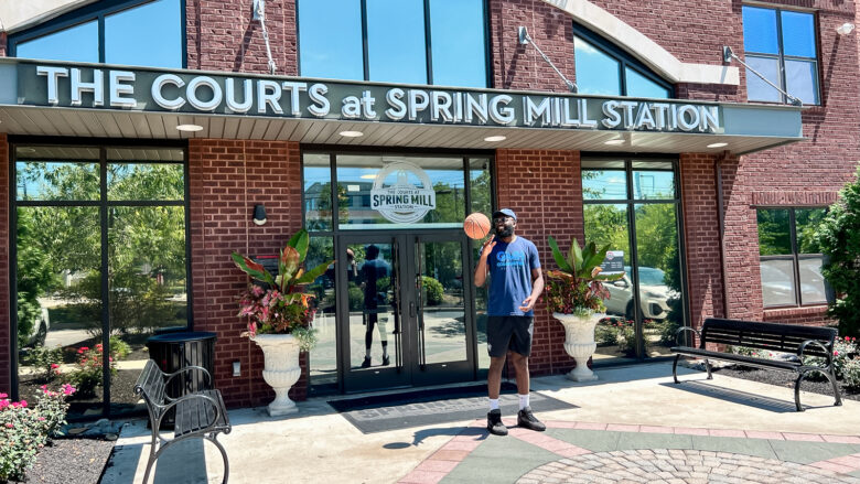 man smiling outside of the courts at spring mill station