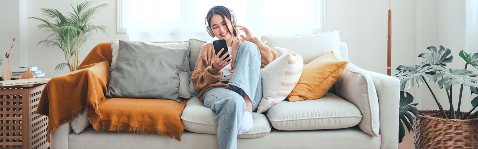 a woman sitting on a couch looking at her phone
